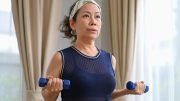 Middle Aged Woman Exercising Dumbells